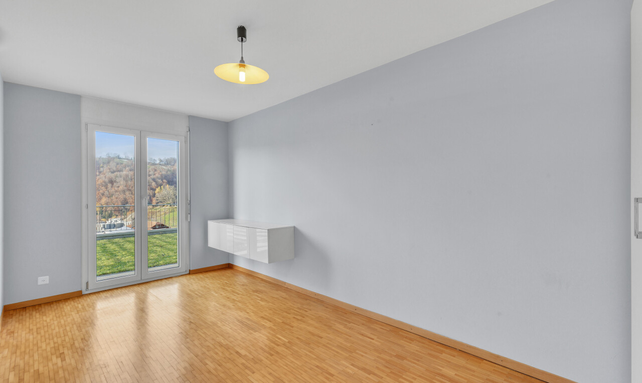 empty room with baseboards and wood finished floors