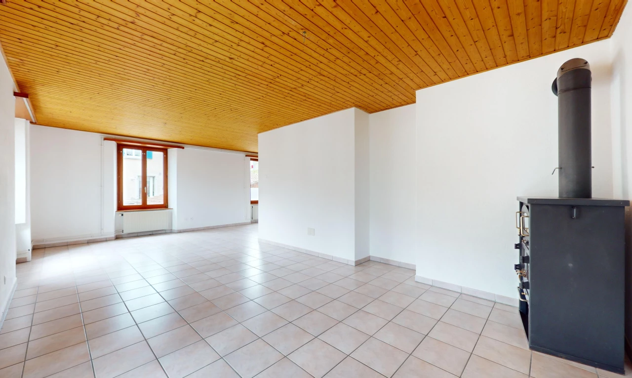 pièce vide avec plafond de bois, lumière naturelle, radiateur, et carrelage