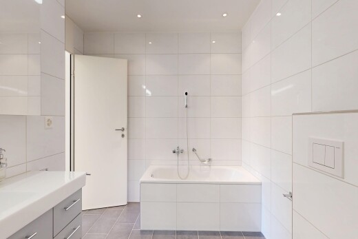 salle de bains avec mur en carrelage, tile wall, lavabo (ou coiffeuse selon le contexte), bain, et salle de bain complète