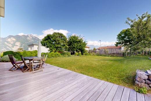 patio / terrace featuring a deck with mountain view and outdoor dining space