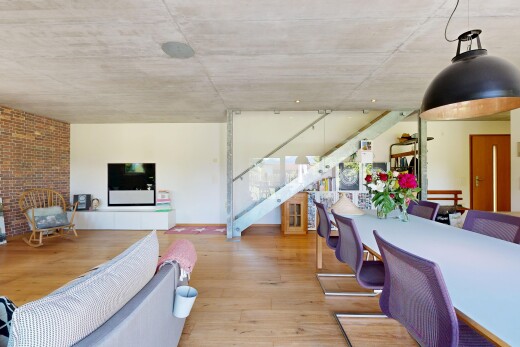 living room featuring light wood finished floors and stairway