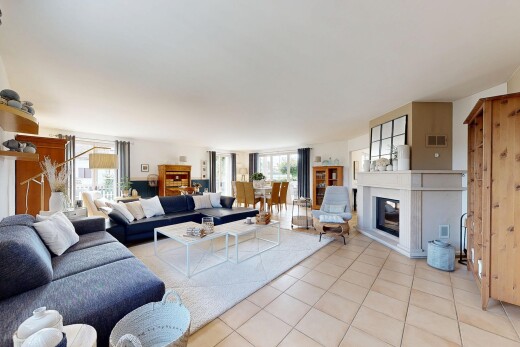 living area featuring tile patterned flooring and a glass covered fireplace