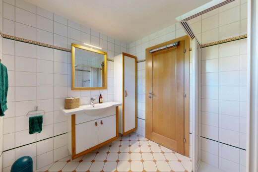 salle de bains avec mur en carrelage, tile wall, miroir, douche, et salle de bain complète