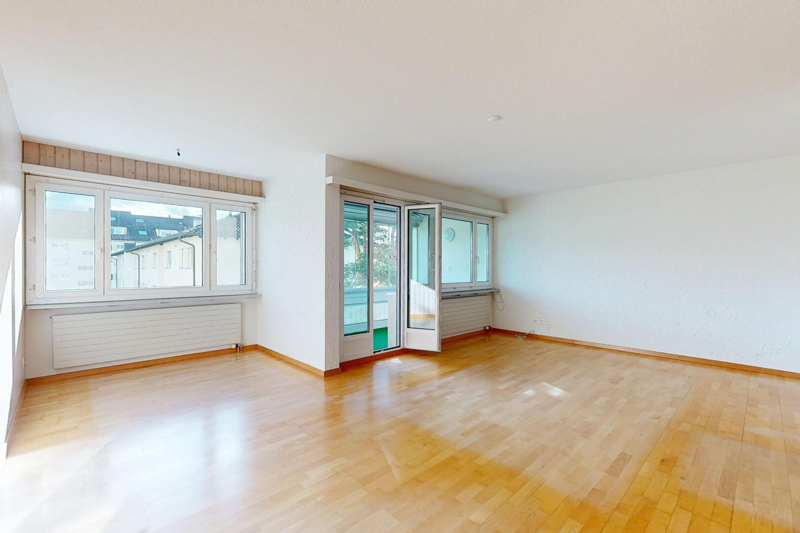 unfurnished room with light wood finished floors and radiator heating unit