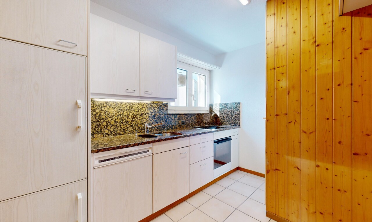kitchen featuring tasteful backsplash, dishwashing machine, light tile patterned floors, and dark stone countertops