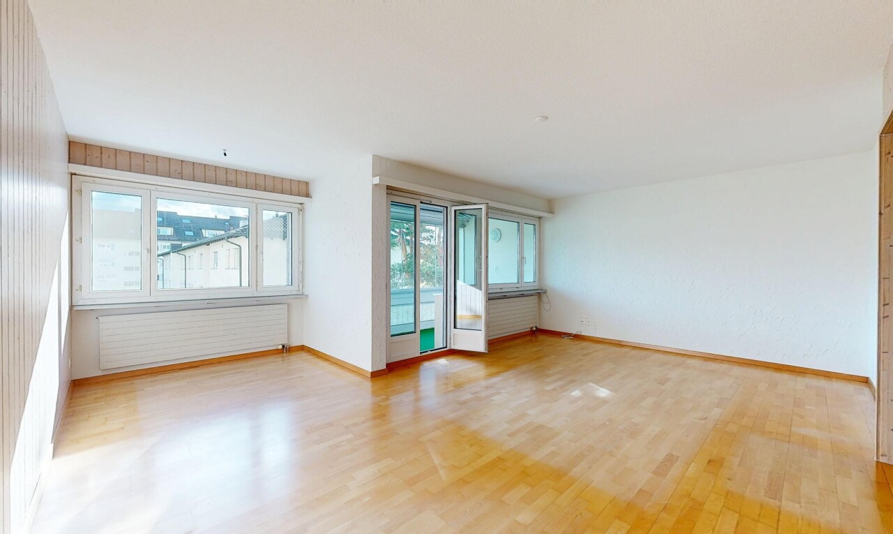 unfurnished room with light wood finished floors and radiator heating unit