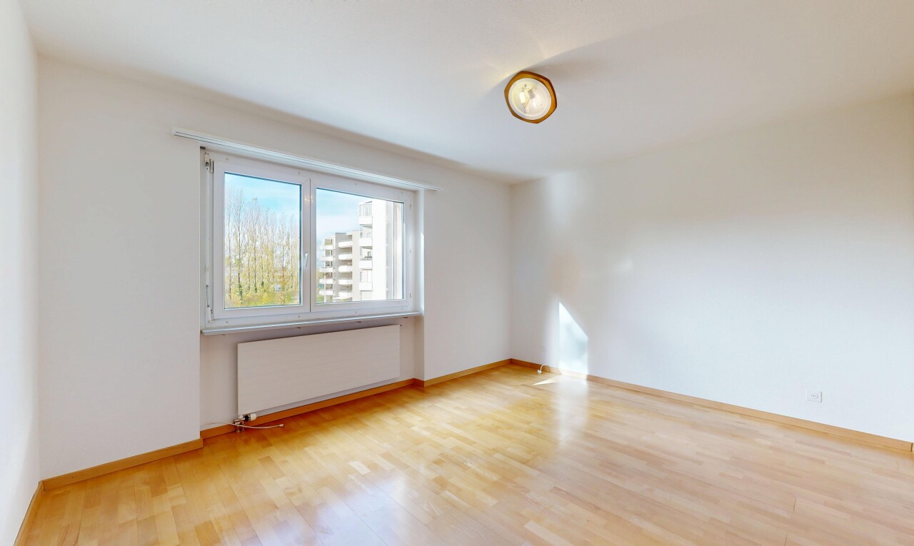 empty room with radiator heating unit and light wood finished floors