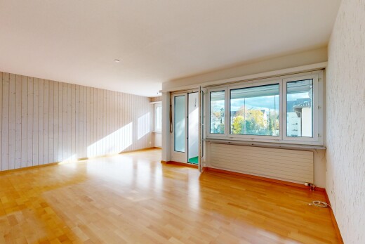 spare room featuring light wood-style floors, radiator heating unit, and wooden walls