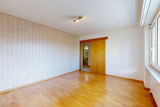 empty room with wood finished floors and wood walls