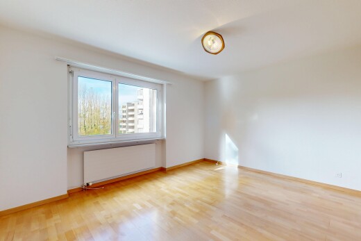 empty room with radiator heating unit and light wood finished floors
