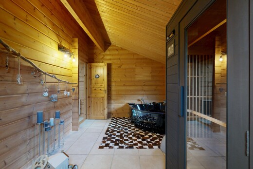 hallway with wood walls, light tile patterned floors, and a vaulted wooden ceiling