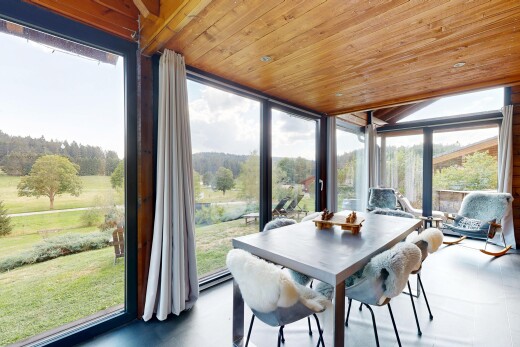 dining space featuring wood ceiling and expansive windows