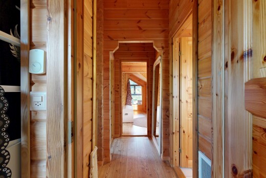hall with wood walls and light wood-style flooring
