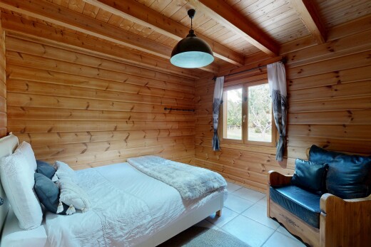 room with hanging light fixtures, wood walls, light tile patterned floors, and a wooden ceiling with exposed beams