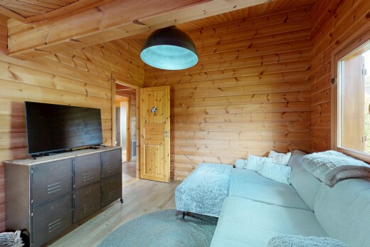living area with light wood-style flooring and wood ceiling