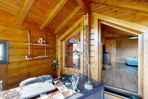 dining room featuring lofted ceiling with beams, wood ceiling, and wood walls