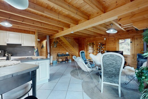 dining area with pendant lighting, a wood ceiling with exposed beams, light tile patterned floors, and wood walls