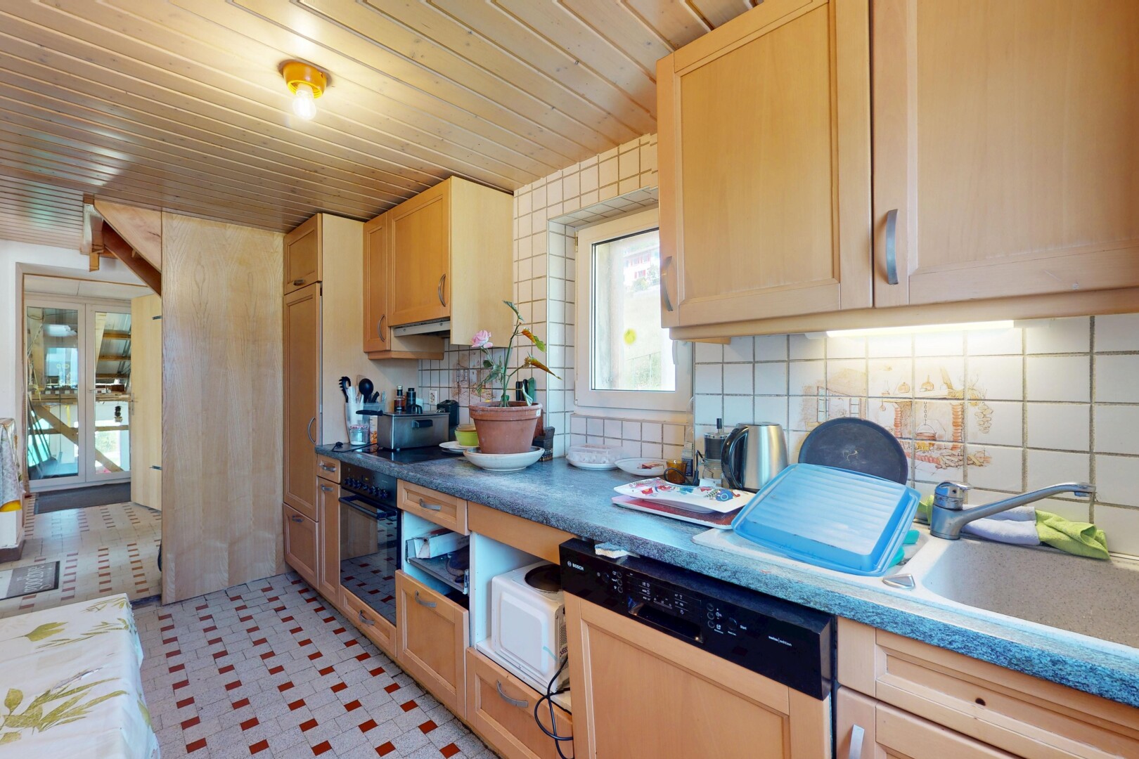 kitchen with dishwasher, oven, decorative backsplash, light brown cabinets, and wooden ceiling