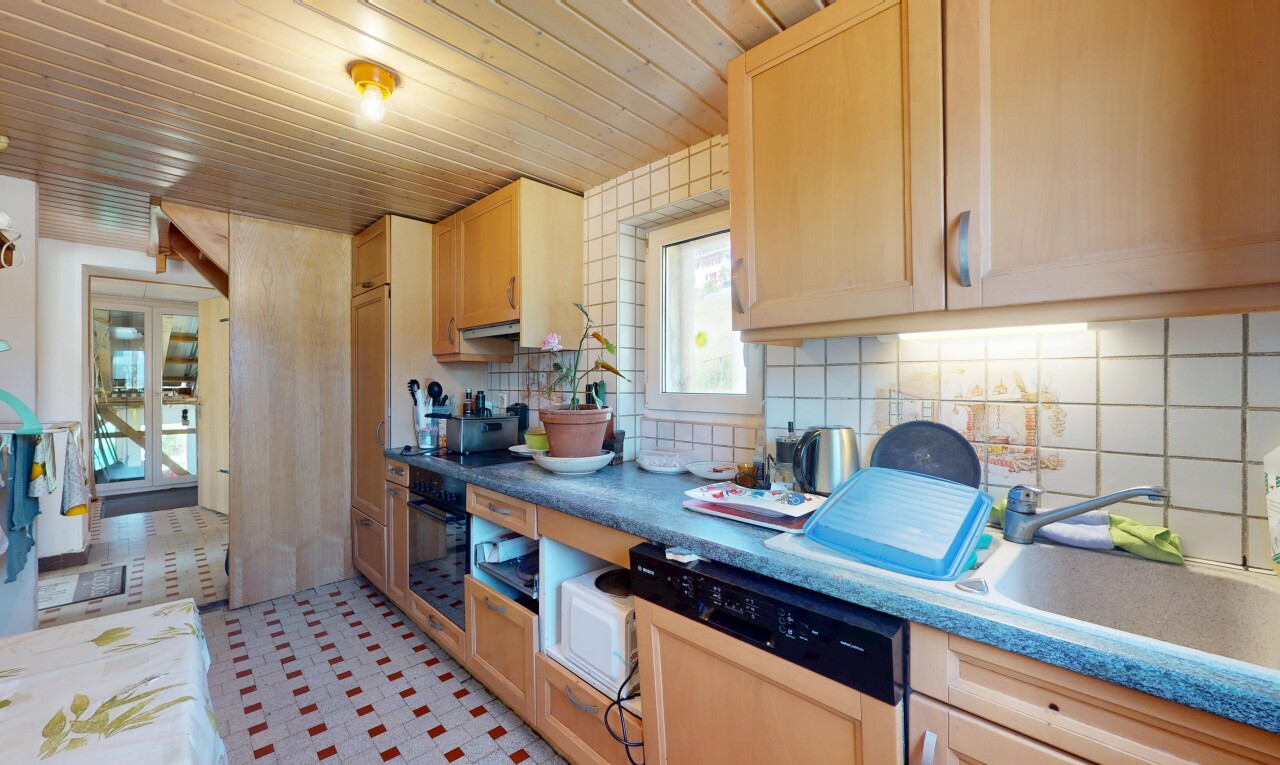 kitchen with dishwasher, oven, decorative backsplash, light brown cabinets, and wooden ceiling