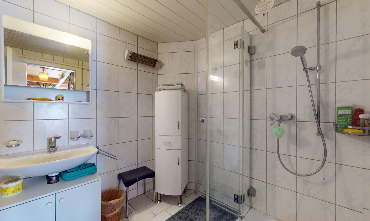 full bath with tile walls, a stall shower, vanity, and tile patterned floors