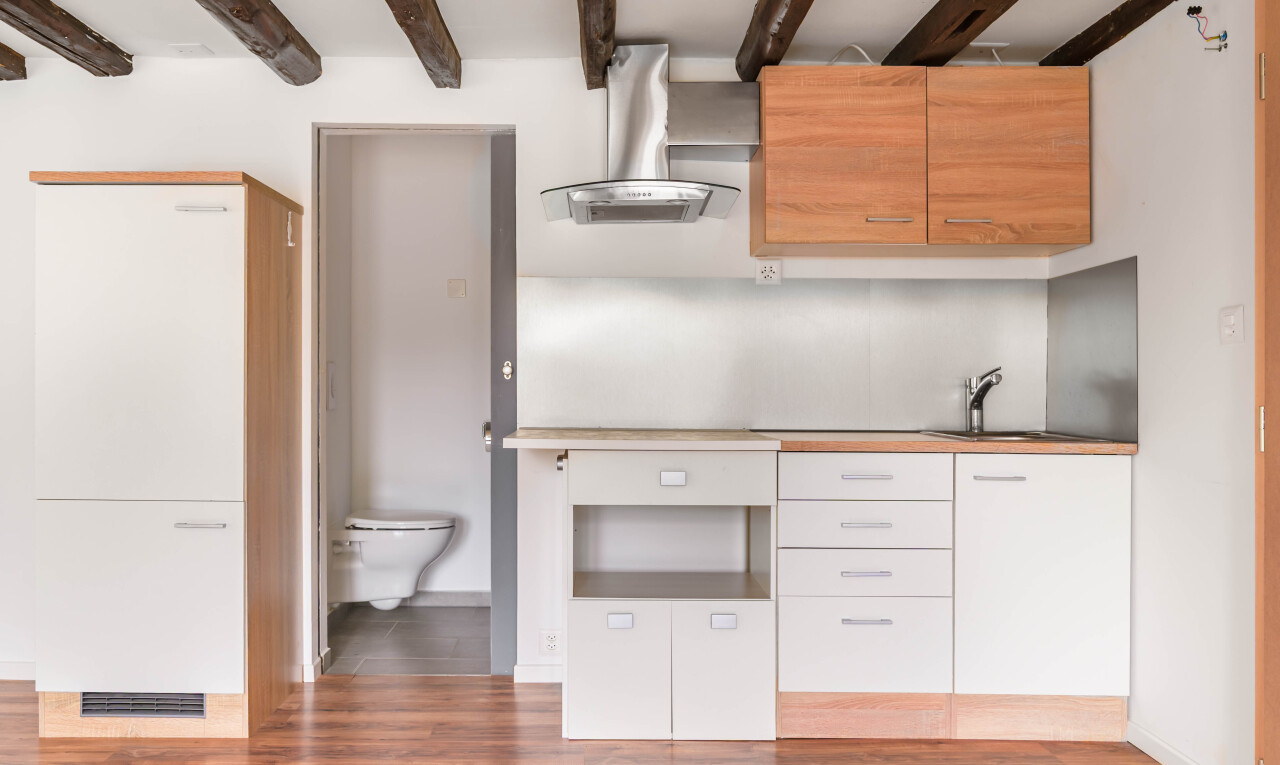 cuisine avec hotte, inside property, wood finish floor, sol en finition bois, et drywall
