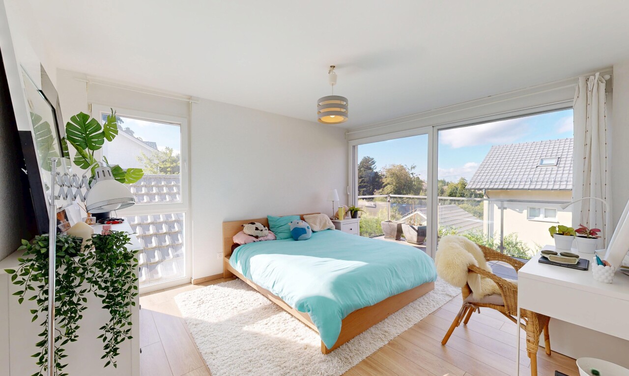 room / bedroom featuring an office area, light wood finished floors, decorative light fixtures, and access to exterior