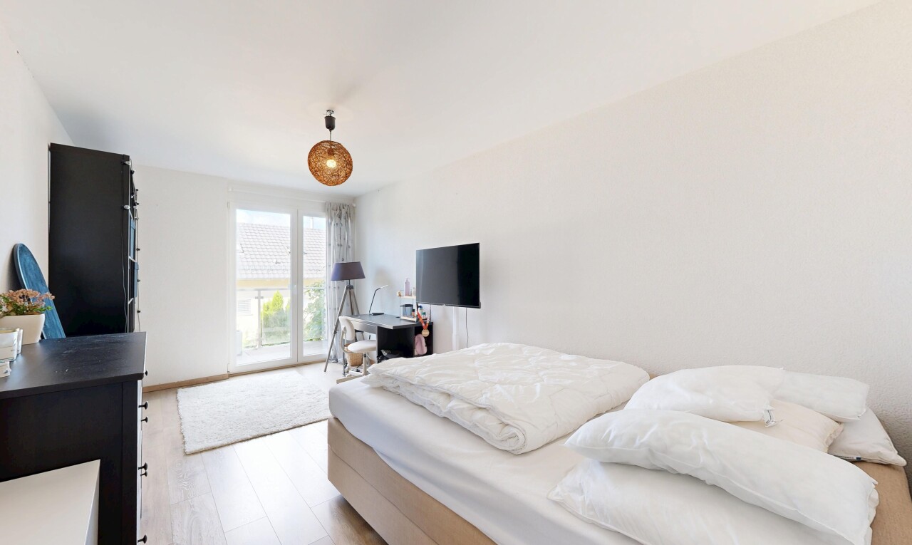 room / bedroom with light wood finished floors, access to exterior, and pendant lighting