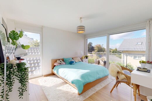 room / bedroom featuring an office area, light wood finished floors, decorative light fixtures, and access to exterior