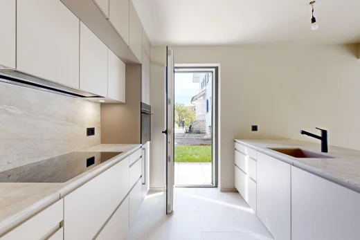 cuisine avec light countertops, plans de travail, évier, accès à l'extérieur, et white cabinets