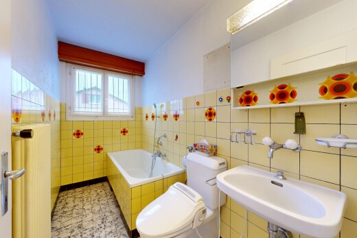 full bathroom with a garden tub and tile walls