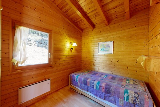 chambre avec beamed ceiling, plafond à poutres, vaulted ceiling, plafond voûté, et wood wall