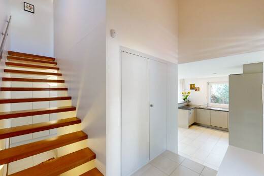 stairway with light tile patterned flooring and a closet