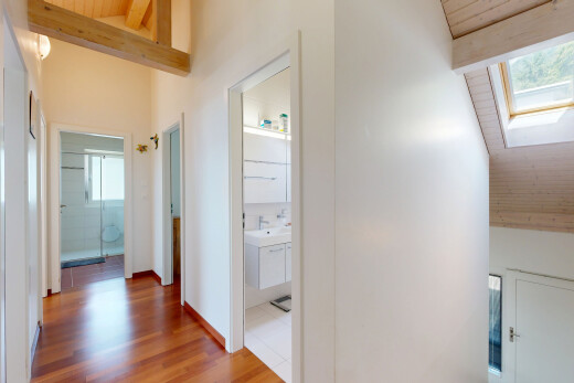 hall with a high wood beamed ceiling and wood finished floors