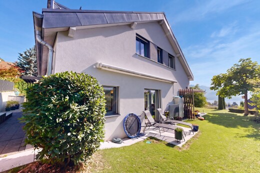 view of home featuring a lawn, stucco siding, and a patio area