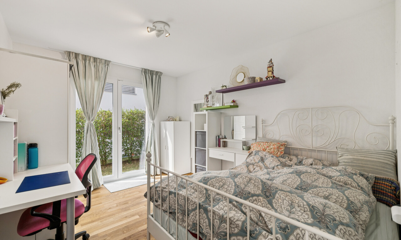 zimmer / schlafzimmer mit bürobereich, außenzugang, drywall, gipskartonwand, und wood finish floor