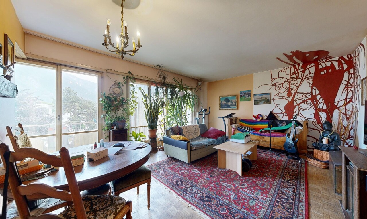 living / dining room with suspended lighting