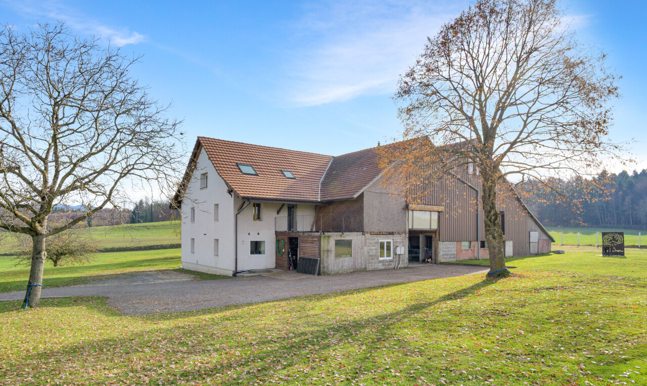 outdoor house featuring a lawn and a balcony