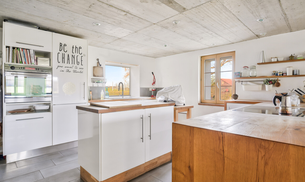 kitchen featuring open shelves, white cabinetry, and oven