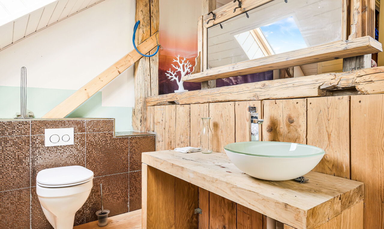bathroom featuring vanity, tile walls, and beam ceiling
