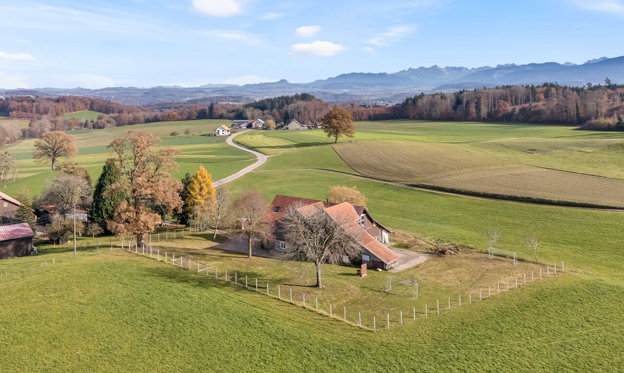 view of mountain backdrop with rural landscape