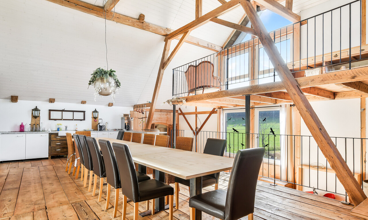 dining space with high vaulted ceiling, beam ceiling, and light wood finished floors