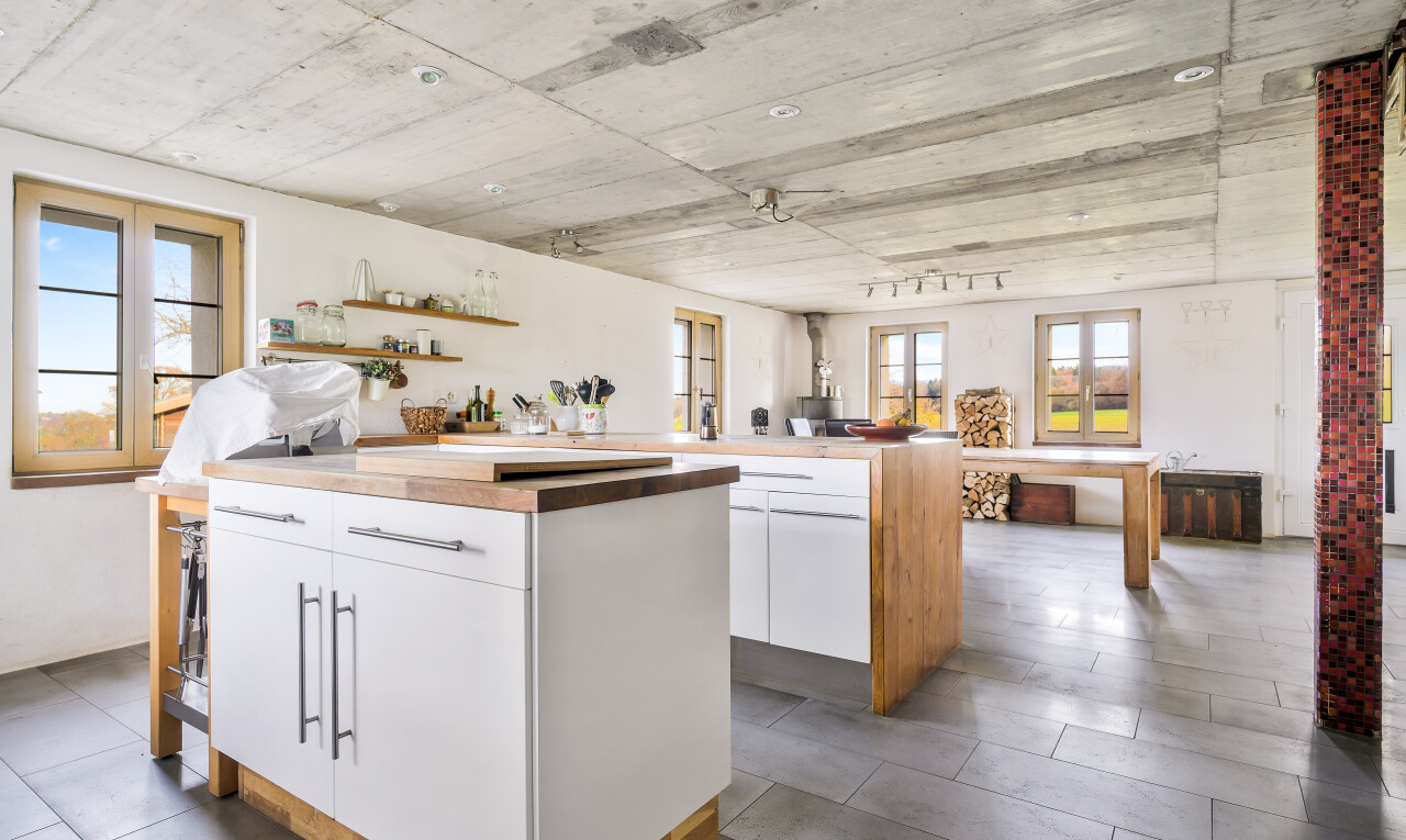 kitchen featuring white cabinets, open floor plan, and a kitchen island