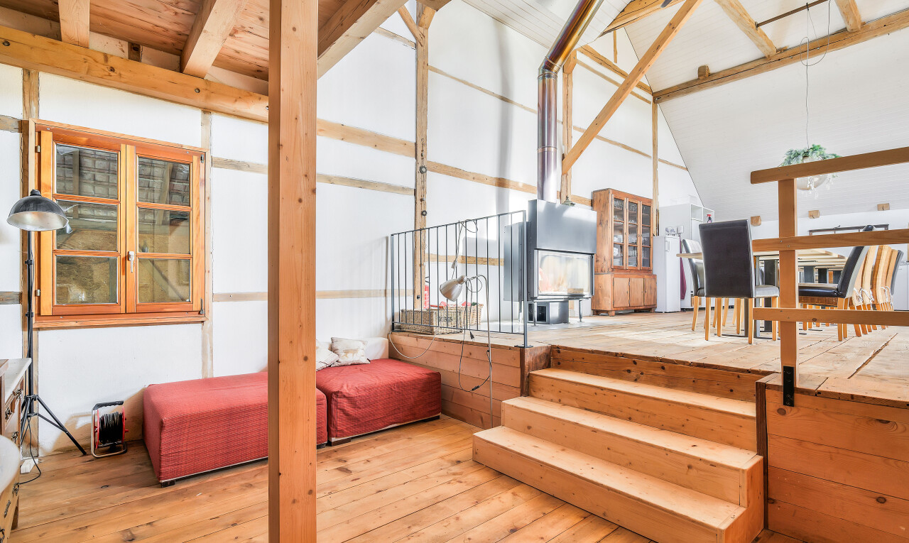 stairs with hardwood / wood-style floors and high vaulted ceiling