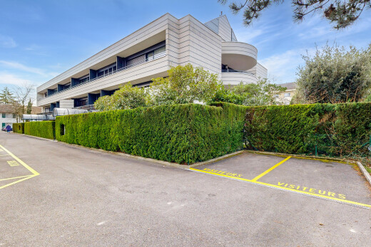 view of apartment building / complex featuring uncovered parking