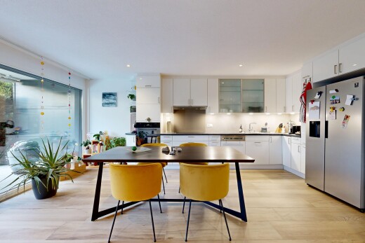 kitchen with white cabinets, stainless steel appliances, glass insert cabinets, decorative backsplash, and light wood-style flooring