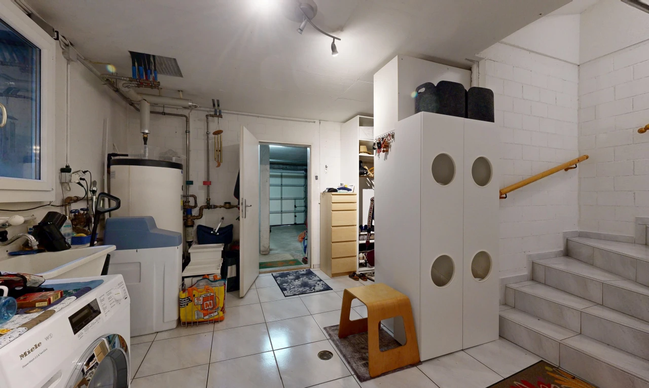 buanderie avec lave-linge et sèche-linge, escaliers, éclairage sur rail, sol en carrelage, et tile floor