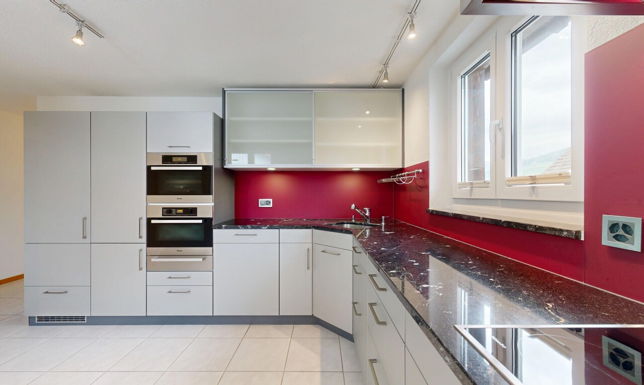 küche mit track lighting, deckenbeleuchtung, dark countertops, light floor, und stone countertops