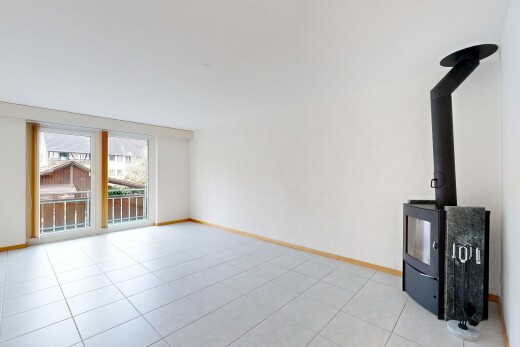 leerer raum mit holzofen, natural light, natürliches licht, inside property, und baseboards wall