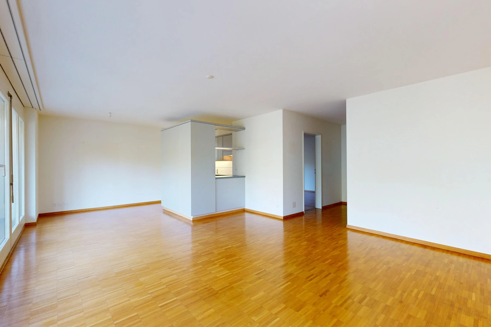 spare room featuring baseboards and light wood-type flooring
