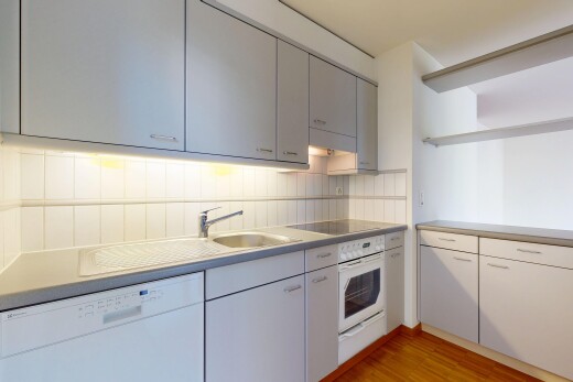 kitchen featuring white appliances, light countertops, light wood-type flooring, gray cabinets, and tasteful backsplash